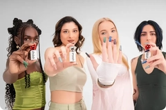 A group of women holding up nail products from iPolish.