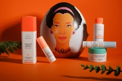 Image Products of Drunk Elephant in front of a balloon with a woman's face on it.