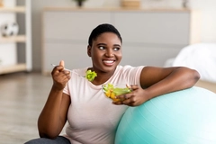 Overweight woman eating a salad