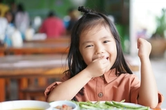 Young Asian girl eating rice Young Asian girl eating rice