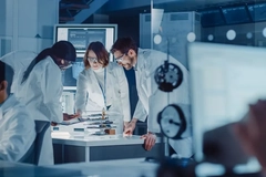 Three scientists gathered around a table.