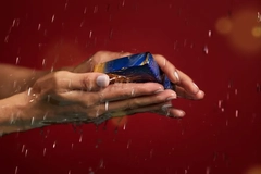 Image Hands washing with black soap.
