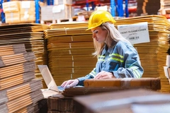 Image Female worker in paper warehouse.