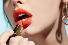 woman applying red lipstick