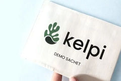 A hand holding a sachet