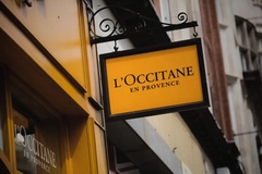 Image L'Occitane logo on a board outside a store