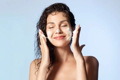 A woman with face wash all over her face.