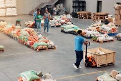Image People, volunteer and food distribution at warehouse, community charity and humanitarian crisis.