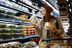 Woman buying fresh food in supermarket.