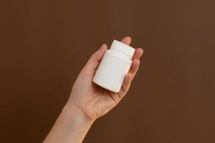 Image A hand holding a plastic bottle