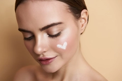 Image peaceful young lady with makeup and heart picture on face
