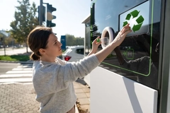 Image woman returns plastic bottles at machine