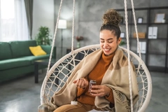 Image woman sitting in a chair taking a supplement