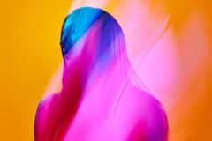 Image A woman with colorful lights all over her.