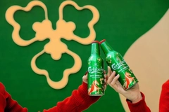 Two hands holding up green cans