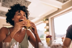 Image woman eating mycoprotein based burger