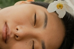 women lies peacefully with eyes closed