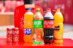 A group of soda bottles and cans on a table