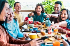 Happy people eating around a table.