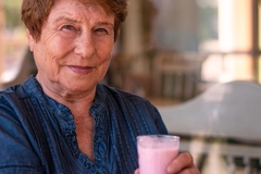 Elderly woman drinking protein shake