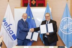 two men in suits shaking hands at a partnership meeting