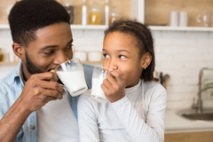 Image Father and daughter drinking milk.