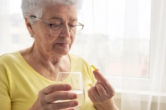 Elderly woman taking omega-6