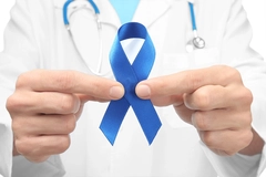 Image Doctor holding blue ribbon, closeup