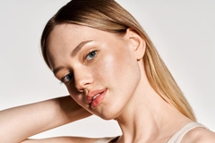 Image woman with glowy skin looks into camera