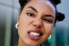Gen Z woman with bold style pulling a silly face