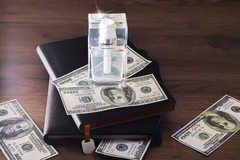 banknotes and a perfume bottle