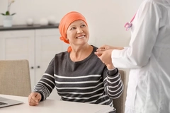 Bald cancer patient with doctor