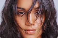 Woman with dark hair in her face