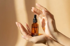 Image A person holding a bottle of liquid