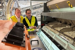 Image Men in yellow vests standing next to a machine