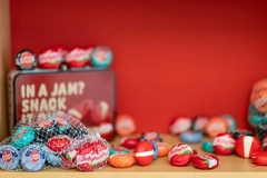 Image colorful packed cheese snacks against red background