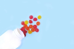 Multicolored jelly candies, vitamins scattered from a jar