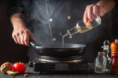 Chef cooking with oil.