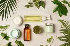 Image Cosmetics on a table surrounded by plants.