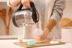 Person making infant formula bottle