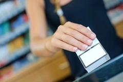 A hand holding a white box of cigarette