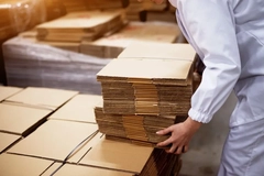 Image person picking up cardboard box