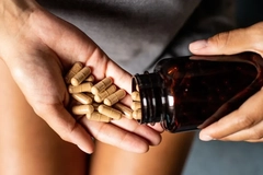 Image woman taking ashwaghanda capsule supplement