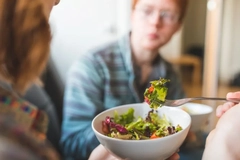 people eating salad on the couch