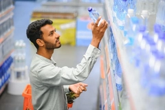 Image man buys water bottle