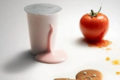 Image A tomato and a cup of yogurt.