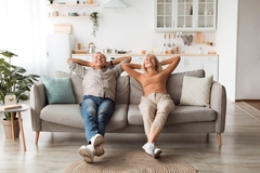 older couple relax on couch