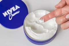 Image Fingers with Nivea cream on them.