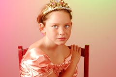 yiung girl looks sad in a pageant dress