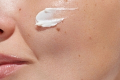 Image closeup of skin with cream on cheek